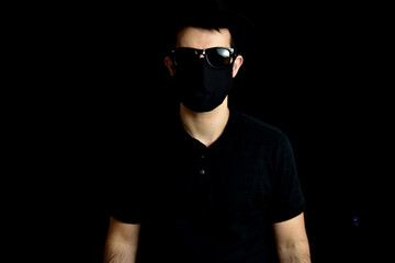 Fototapeta premium Man in hat, glasses and mask on black background.