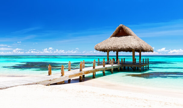 Panorama of beautiful gazebo on the tropical white sandy beach in Punta Cana, Dominican Republic.