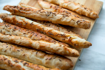 Homemade baked grissini sticks sprinkled with caraway seeds