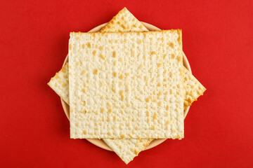 Matzah in the form of a star of David on a red background.