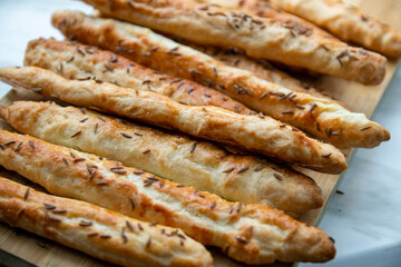 Homemade baked grissini sticks sprinkled with caraway seeds