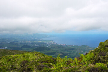 Gray rain clouds over hills and lakes in Sao Miguel island. Travel to the Azores.