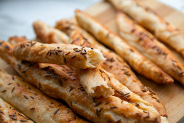 Homemade baked grissini sticks sprinkled with caraway seeds