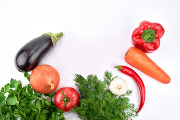 Food background. Seasonal vegetables and greens on a white table. Top view, flat lay