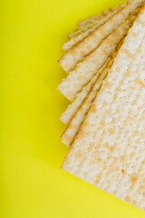 Pesach matzo on a yellow background.Vertical frame