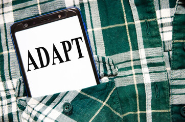 adapt word written on white piece of paper and yellow background