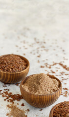 Raw Flax seeds flour and seeds in bowls