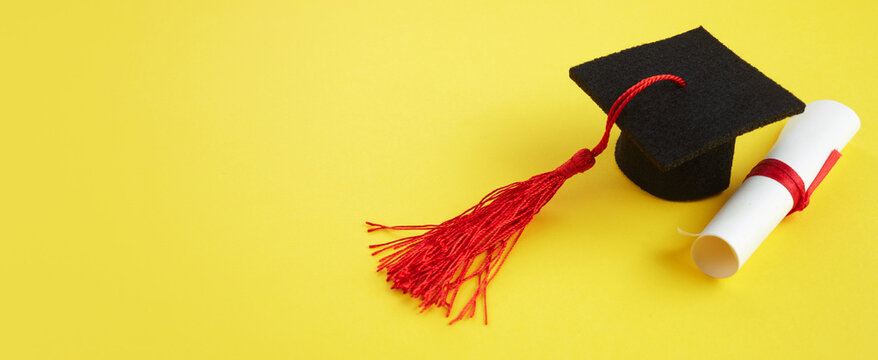 Academic hat with diploma on yellow background. Graduation theme