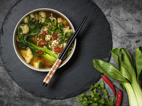 Miso soup with pak choi, mie noodles and chili pepper, Japanese Food. dark background