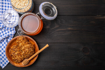 oatmeal cookies with cereals and honey on a dark wooden background top view