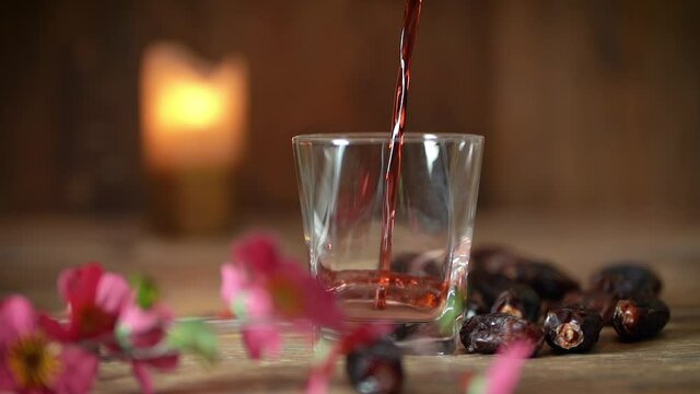 Pouring Arabian juice of jallab with nuts served in holy month of Ramadan