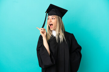 Young university graduate over isolated blue background intending to realizes the solution while lifting a finger up