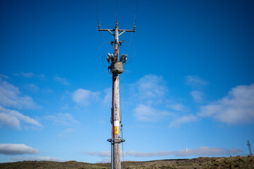 electric power lines and a wooden pole