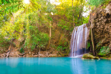 Tropical landscape with beautiful waterfall, wild rainforest with green foliage and flowing water