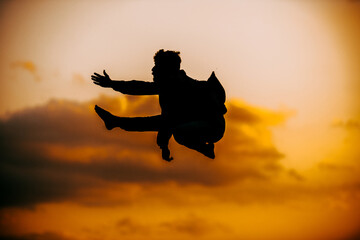 Teenager dancing breakdance in action while leaps through the sky