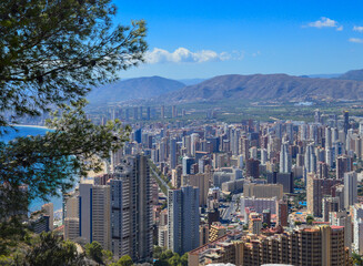 Mountain view of the Benidorm high-rises and the sea on a sunny day