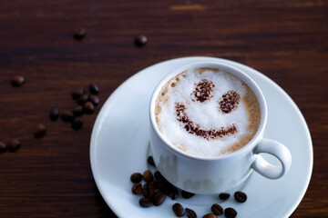 Coffee with milk and chocolate chips on the table.