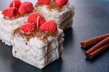 Beautiful colorful bright candle made in the form of an appetizing cake. Aromatherapy, candle with the smell of herbs