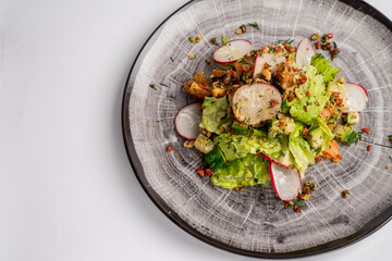 Fresh mix of salads with vegetables on a plate. Top view. Space for text