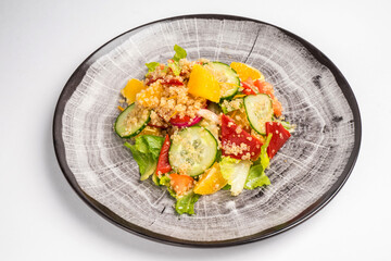 Fresh mix of salads with vegetables on a plate. Top view. Space for text