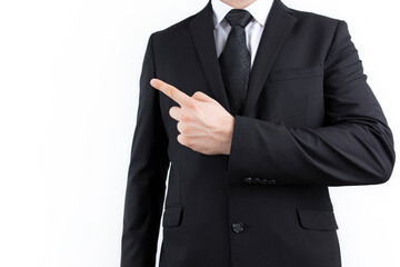 young successful businessman. Man on white background, wearing suit with tie and pointing with his finger at copy space.
