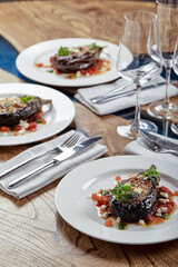 Half baked eggplants with meat, cheese and tomatoes on white background. Banquet festive dishes. Gourmet restaurant menu. White background.