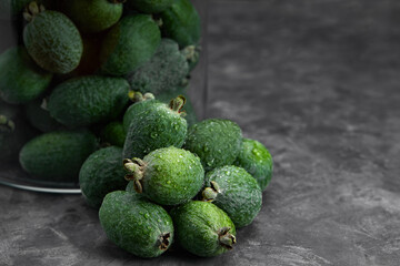 Feijoa whole on black background. Exotic fruit. Selective focus. Closeup.