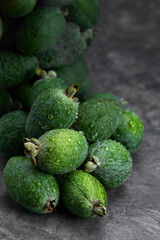 Feijoa whole on black background. Exotic fruit. Selective focus. Closeup.