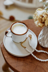 Coffee cup cappuccino, vintage dried flowers, cozy home. Hygge, Lagom, Moody. Cosy autumn winter concept