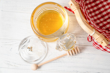 Top view of honey container on wooden table. Best honey dispenser
