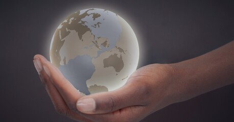 Composition of glowing globe over man's hand