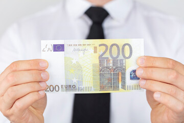 Business man holding a European euro. struggling with the global economic crisis.
