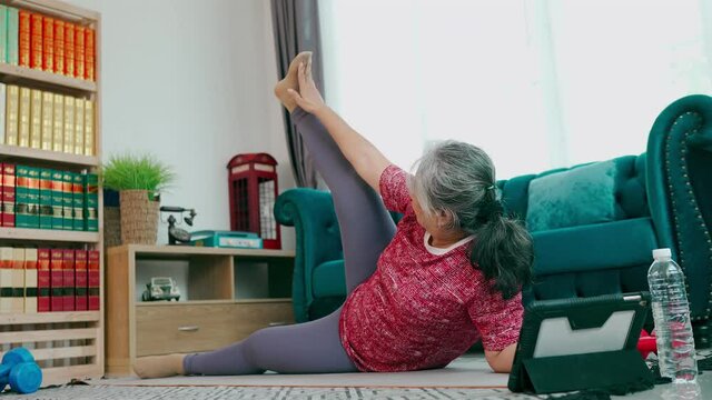 Healthy senior woman exercise with side-lying leg lift