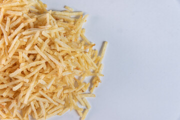 White bowl with potato straw on white background