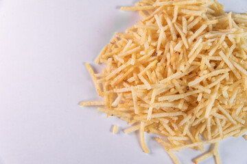 White bowl with potato straw on white background