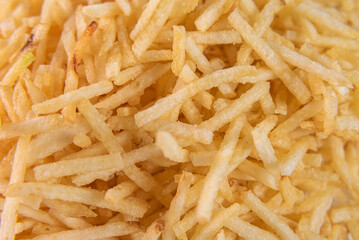 White bowl with potato straw over background
