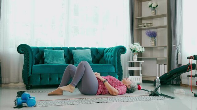 Healthy senior woman exercise with lying leg lift
