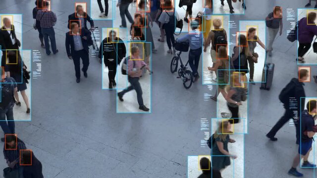 High view of commuters walking. Anonymous crowd with facial recognition interface showing personal data for each person. Surveillance concept. Artificial intelligence. Deep learning.