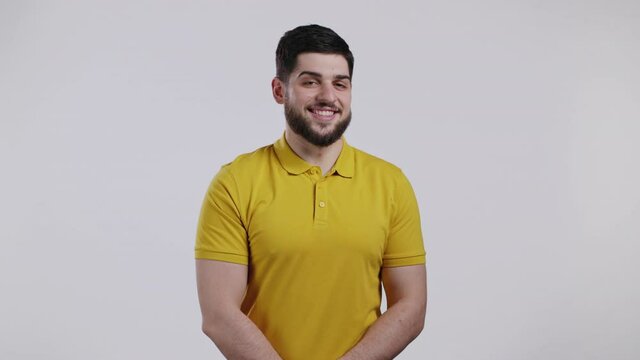 Portrait of cheerful georgian man looking to camera. Young handsome kind guy with beard smiling in studio on white background.