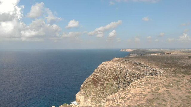Aerial shot Lampedusa Island (Drone 4k), seagulls, isola dei conigli at sunset - concept of paradise on earth, happiness and travel to beautiful places