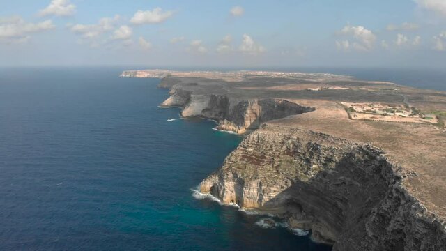 Aerial shot Lampedusa Island (Drone 4k), seagulls, isola dei conigli at sunset - concept of paradise on earth, happiness and travel to beautiful places