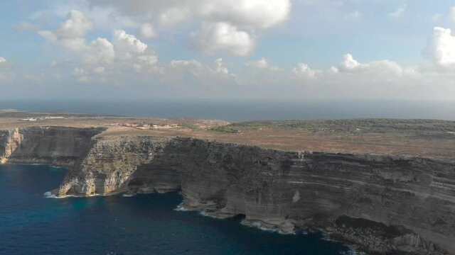 Aerial shot Lampedusa Island (Drone 4k), seagulls, isola dei conigli at sunset - concept of paradise on earth, happiness and travel to beautiful places