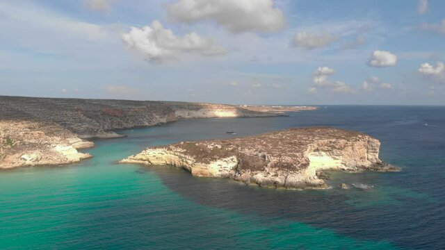 Aerial shot Lampedusa Island (Drone 4k), seagulls, isola dei conigli at sunset - concept of paradise on earth, happiness and travel to beautiful places