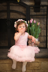 Close Up Portrait, 2 Years Old Toddler Girl with Big Blue Eyes, in light Pink Dress with Pink Flowers on her head, Sitting by the fireplace, Birthday Girl, Ukrainian Head bend, Little Princess 