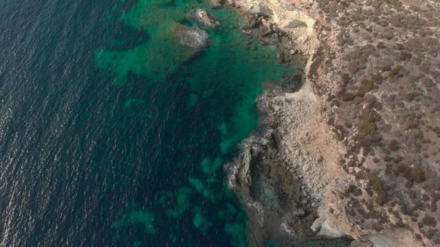 Aerial shot Lampedusa Island (Drone 4k), seagulls, isola dei conigli at sunset - concept of paradise on earth, happiness and travel to beautiful places