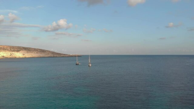 Aerial shot Lampedusa Island (Drone 4k), seagulls, isola dei conigli at sunset - concept of paradise on earth, happiness and travel to beautiful places