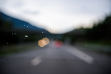Defocused bokeh focus blur on the raindrops on the car