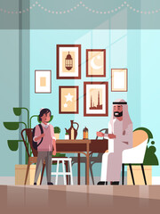 muslim family celebrating ramadan kareem holy month living room interior arabic father and son in traditional clothes spending time together flat vertical full length