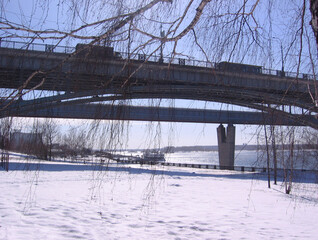 automobile bridge in Novosibirsk embankment by the river in winter landscape in the snow