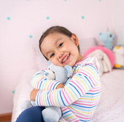 Beautiful girl child in pink bedroom.